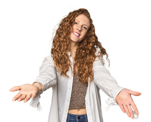 Simple redhead studio portrait showing a welcome expression.