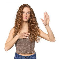 Simple redhead studio portrait taking an oath, putting hand on chest.
