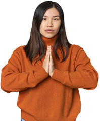Young Chinese woman praying, showing devotion, religious person looking for divine inspiration.