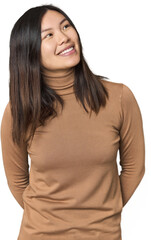 Young Chinese woman relaxed and happy laughing, neck stretched showing teeth.