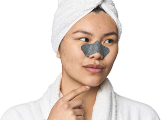 Chinese woman in robe with pore strip on nose in studio