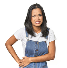 Simple portrait of a young Latina having a liver pain, stomach ache.