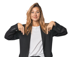 Young businesswoman in a suit points down with fingers, positive feeling.