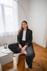 Young woman posing calmly in a stylish home interior