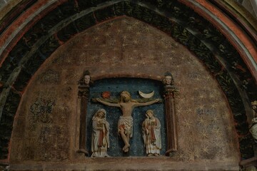 Gothic relief of Calvary scene inside Burgos Cathedral cloister