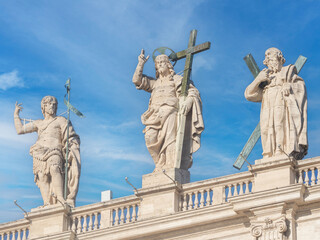 Obraz premium Statues of Saint John the Baptist, Christ the Redeemer and St Andrew on the facade of San Peter Basilica, Rome, Italy