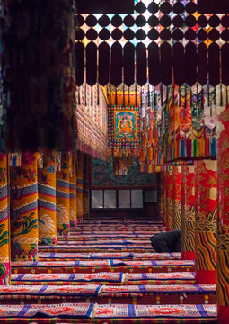 Monks praying and meditating inside Longwu monastery, Tongren County, Longwu, China