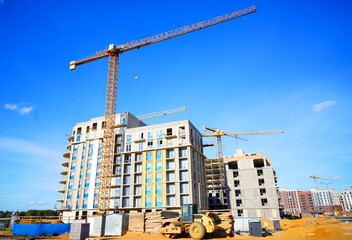 Tower crane on apartment Construction. Block House building construction. Apartments construction. Housing renovation, real estate. Crane on formwork in Built environment. Cranes on pouring concrete.