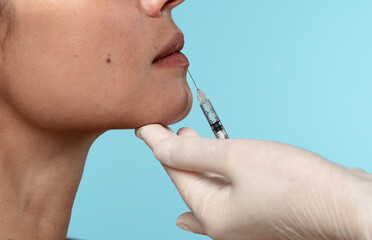Close-Up of Lip Filler Injection Procedure with Syringe and Gloved Hand