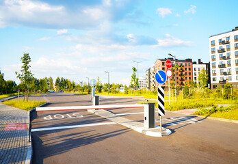 Automatic car barrier in Private urbanization residential area. Car barrier in front yard in Condominium. Barrier Gate on parking lot. Barrier for entry and exit to parking lot for residents of area.