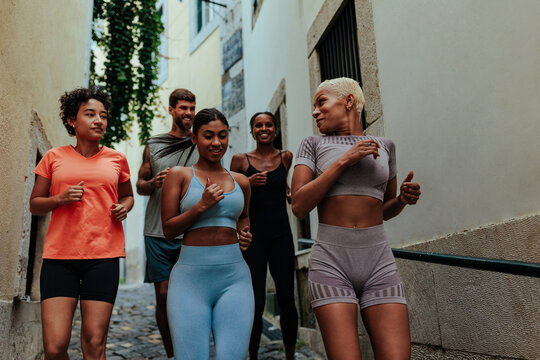 Group of athletes running through lisbon's picturesque streets