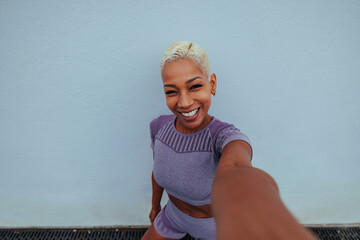Fitness blogger taking a photo of herself after outdoor workout