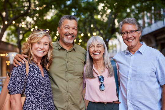 Portrait of happy mature friends smiling outdoor