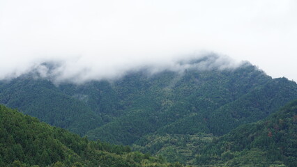 The beautiful mountains landscapes with the green bamboo forests and little country road as background in the countryside of the China