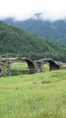 One old traditional Chinese village view with the old arched stone bridge in the Southern countryside of the China