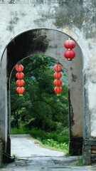 The beautiful traditional Chinese village view with the classical architecture and fresh green trees as background

