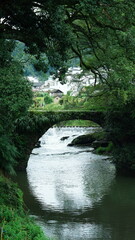 One old traditional Chinese village view with the old arched stone bridge in the Southern countryside of the China