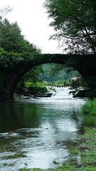 One old traditional Chinese village view with the old arched stone bridge in the Southern countryside of the China