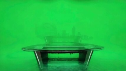 Green Screen Studio Set with Glass Table and Cityscape Silhouette