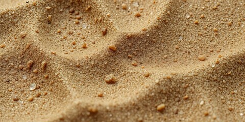 Close-up of damp sand, showing intricate texture and subtle wet sheen,  light,  outdoors