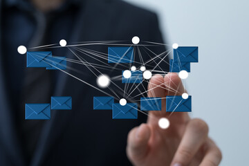 Businessman connecting emails. Network, communication, technology concept. Stock photo.