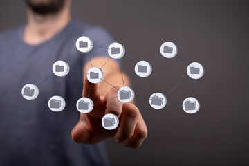 Image of a person interacting with a digital network of files, representing data management or...