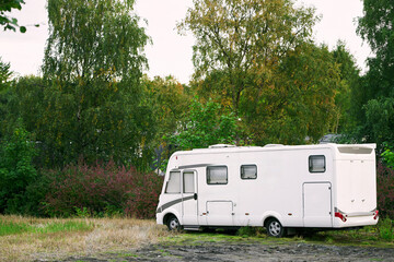 Motorhome parked outdoors in a forest setting