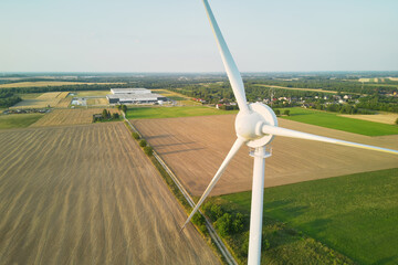 Wind turbine in an open field at sunset