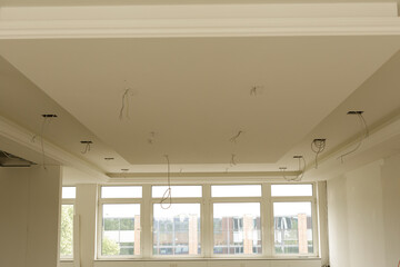Modern home renovation featuring a new ceiling installation and recessed lighting.  High-quality...