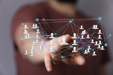 Image of a hand interacting with a digital network of people, representing social media connections...