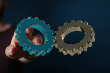 Image of two gears interlocked, symbolizing teamwork, collaboration, and synergy.