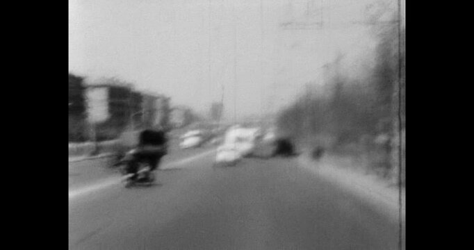 Traffic on a busy city road, traffic from cars, residential buildings and trolleybus wires. Archive video of Minsk in the 1970s, Belarus