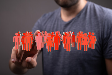 Stock photo of a person interacting with a digital representation of a diverse group of people,...