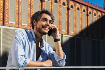 Portrait of a young businessman talking on the phone