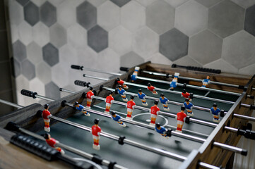 table football with figures of players in red and blue uniforms.