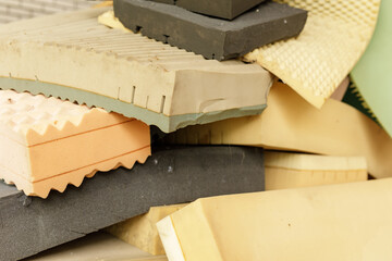 Various used foam pieces from mattresses, ideal for recycling or upcycling projects.