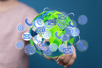 Image of a person interacting with a digital globe showing email, phone, and internet connection...