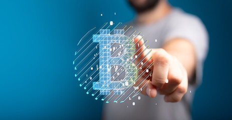 Close-up of a person interacting with a digital Bitcoin symbol. Cryptocurrency, finance, technology.