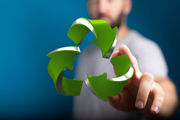 Sustainable eco-friendly recycling concept.  Man interacts with 3D green arrows.