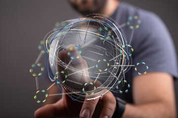 A person interacts with a futuristic digital globe hologram. Technology, innovation, and global...