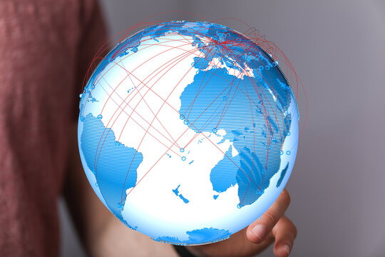 Person holding a digital globe illustrating global connectivity and networking.