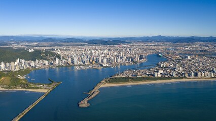 Fototapeta premium Aerial view of Itajaí cityscape with the port in the background on a clear sunny day.