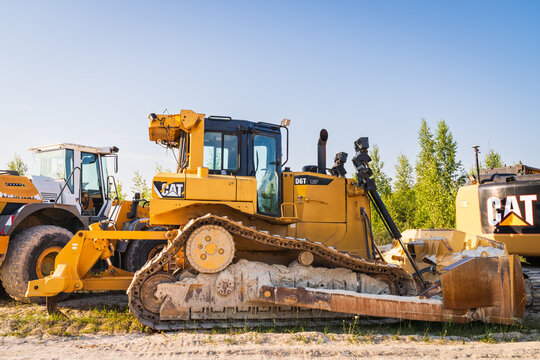RUMMU, ESTONIA - JULY 20, 2025: A Caterpillar D6T LGP heavy bulldozer parked with other construction machinery at the Rummu quarry.