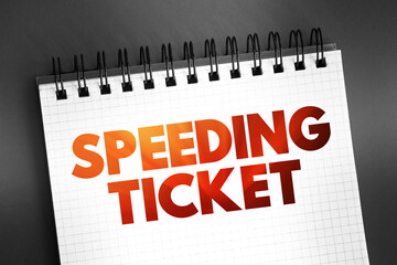 Speeding ticket - a ticket issued for driving above the speed limit, text on notepad concept background