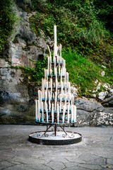 burning candles at The Grotto of Massabielle in lourdes france