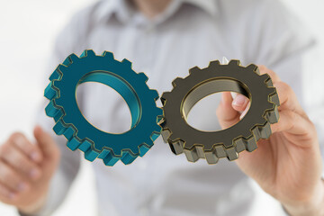 Image of two gears meshing, symbolizing teamwork, collaboration, and efficient workflow.
