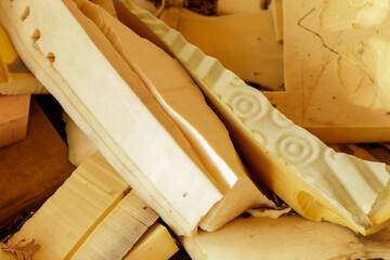 Pile of used foam padding pieces, great for upholstery projects or DIY crafts.