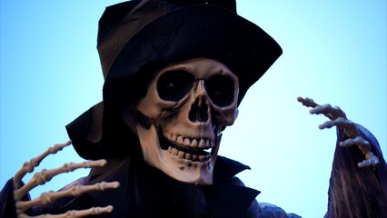 Scary Halloween monster donning a black hat and cloak, revealing skeletal hands against a vibrant...