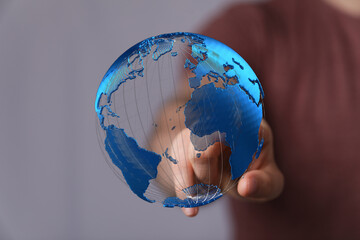 High-tech image of a person interacting with a digital globe, representing global connections and...