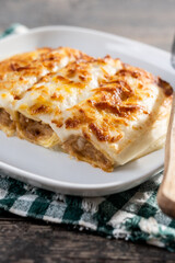 Baked Cannelloni with Cheese and Béchamel Sauce on wooden table